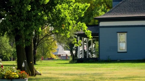 A blue house beneath tall trees on a Lebanon street Video stock 345530562
