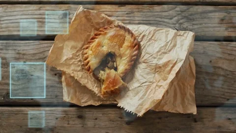 Blue HUD squares appearing left drifting over wood while pie sitting on paper Stock Footage 333720418