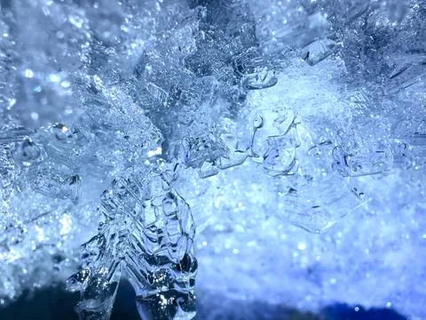 Blue-hued ice crystals with sharp, detailed structures, close-up Stock Photos