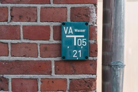 Blue hydrant table on red brick wall Stock Photos