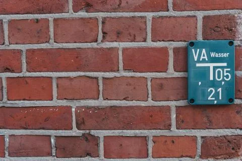 Blue hydrant table on red brick wall Stock Photos