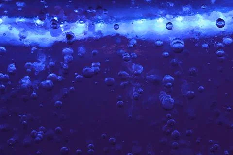 Blue ice with air bubbles close-up. Modern Abstract Background Blue Water Design Stock Photos