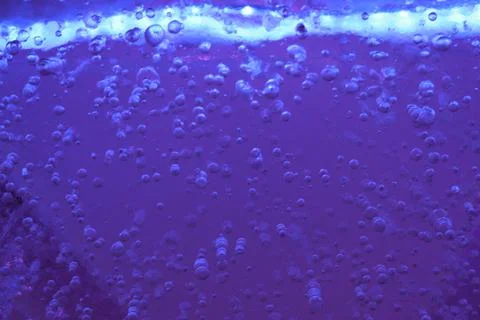 Blue ice with air bubbles close-up. Modern Abstract Background Blue Water Design Stock Photos