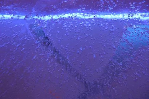 Blue ice with air bubbles close-up. Modern Abstract Background Blue Water Design Stock Photos