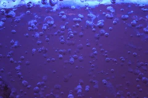 Blue ice with air bubbles close-up. Modern Abstract Background Blue Water Design Stock Photos