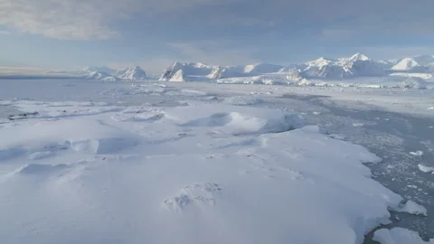Blue ice cave in white glacier on Antarctic Peninsula. Aerial shot close-up. Stock Footage 267867366