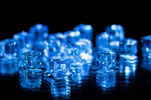 Blue ice cubes on the black background Stock Photos