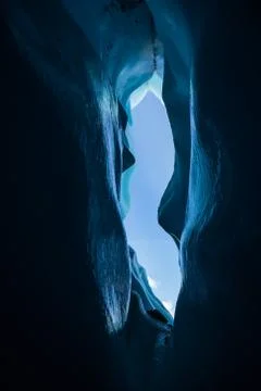 Blue ice of a deep ice cave with wavy walls of the Matanuska Glacier in Alask Stock Photos
