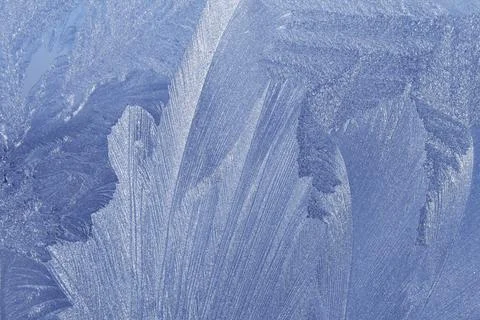Blue ice pattern on winter glass Stock Photos