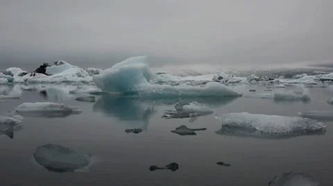 Blue iceberg floating in Glacier lagoon on a foggy evening, Iceland Stock Footage 33778507
