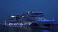 Blue illuminated AIDA Stella leave harbour with horn sound HD Footage