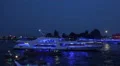 Blue illuminated yacht cruising night in Hamburg harbour HD Footage