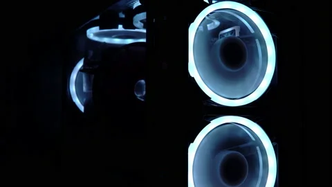 Blue illumination of the fan in the pc case. Blue blades spin to cool computer Video stock 161263976