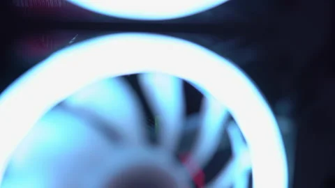 Blue illumination of the fan in the pc case. Blue blades spin to cool computer Stock Footage 161264329
