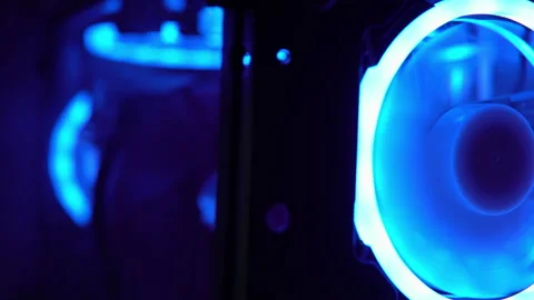 Blue illumination of the fan in the pc case. Blue blades spin to cool computer Stock Footage 161264614