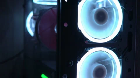 Blue illumination of the fan in the pc case. Blue blades spin to cool computer Stock Footage 161265508