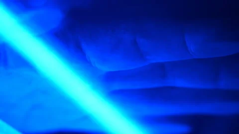 Blue illumination of the moving scanner lamp is scanned the male palm Stockbeeldmateriaal 141962648