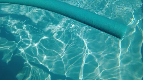 Blue inflatable floating in a pool on a sunny day. Slow motion, 4K video. 스톡 동영상 245063502