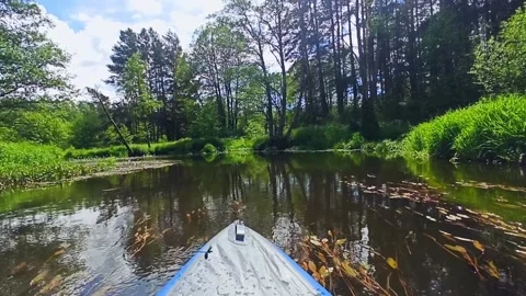 A blue inflatable kayak quickly floats down the river Stock Footage 234885901
