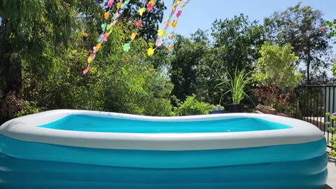 Blue inflattable pool with water at the backyard Stock-Footage 200863648