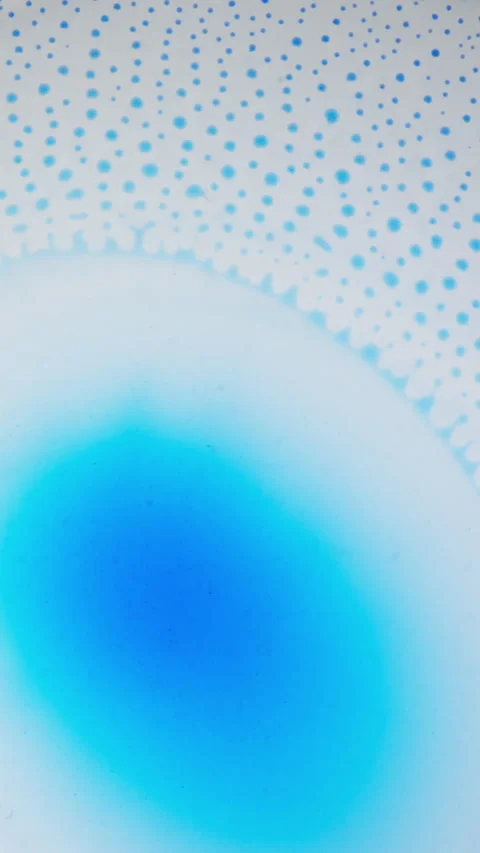 Blue Ink Diffusing and Forming Circular Cell Patterns in Liquid, Macro Vertical Stock Footage 340883373