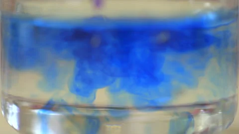 Blue Ink Diffusing in Clear Water Close Up Stock Footage 339018220
