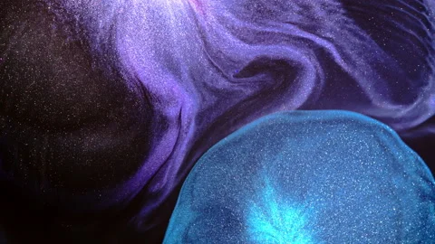 Blue Ink Dome Rising Beneath Swirling Violet Glitter Pigment 動画素材 346606792