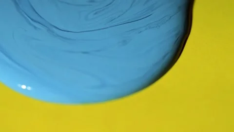 Blue Ink dropping and spreading on yellow paper 스톡 동영상 152647975