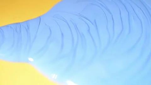 Blue Ink dropping and spreading on yellow paper Vídeos de archivo 152648331