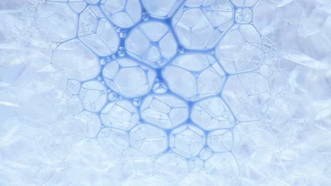 Blue ink flowing through bubbly pattern Stock Footage 127867545