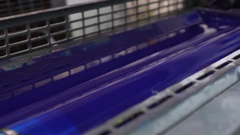 Blue ink rollers operating inside offset printing press mechanism Stock Footage 321540022