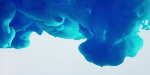 Blue ink in water in slowmotion on a white background. Stock Footage