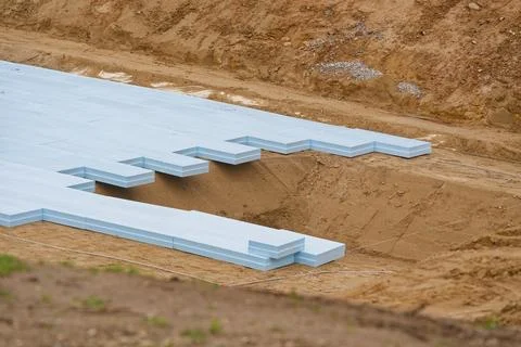 Blue insulation foam panels installed on construction site foundation trench Stock Photos