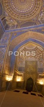 Blue interior of mosque dome with gold gild of Tile Karl Madrasa in The Regis Stock Photos