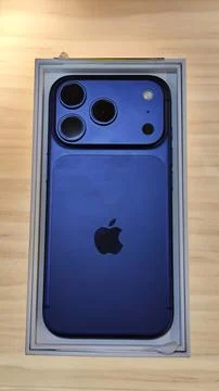 Blue iPhone 17 Pro Max unboxed with tech focus. Stock Photos