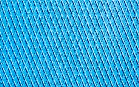 Blue iron wall with intersecting lines close up Stock Photos