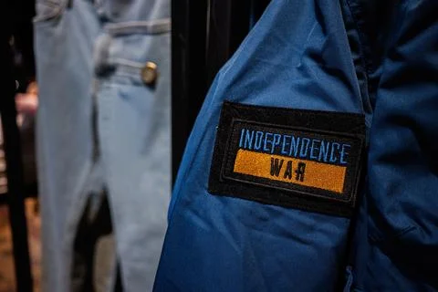 Blue Jacket Patch Signifying Independence War with Denim Jeans in Background Stock Photos