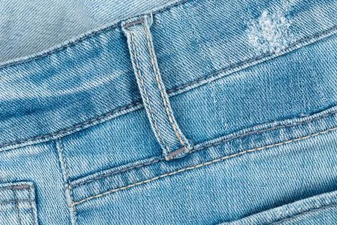 Blue jeans texture with belt loop and stitching detail. Macro view of denim.. Stock Photos