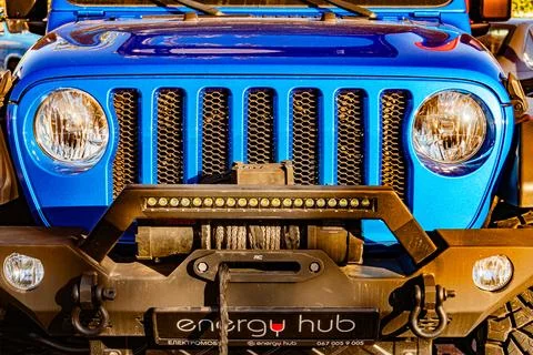 A blue Jeep Wrangler, emphasizing rugged features like round headlights, sq.. Stock Photos