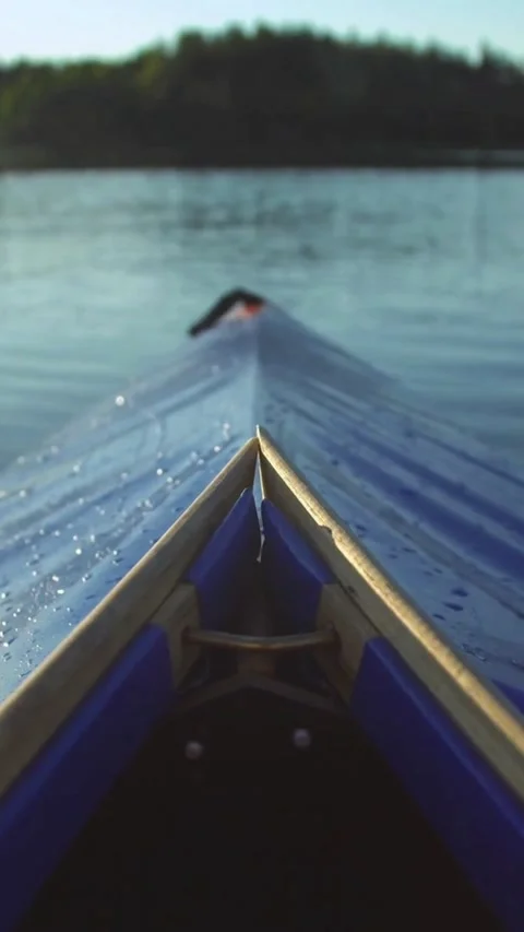 Blue kayak bow cutting through the calm lake water Stock-Footage 334184245