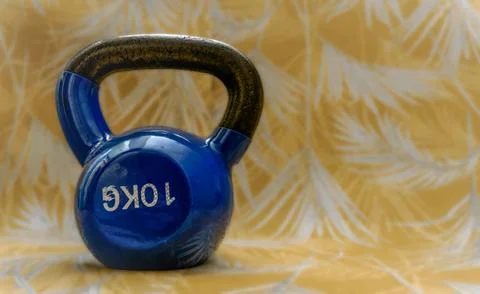 Blue kettlebell resting on patterned background Stock Photos