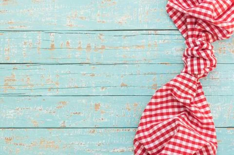 Blue kitchen table background with rustic red fabric napkin Stock Photos