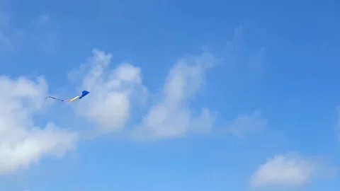 Blue Kite Flying High In Peaceful Sky Background Template Childhood Fun Toy Stock Footage 323085899