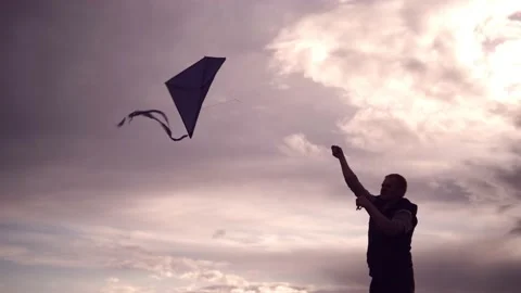 Blue kite soars in the sunset sky. Stock Footage 153415421