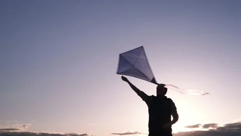 Blue kite soars in the sunset sky. Stock Footage 153415530