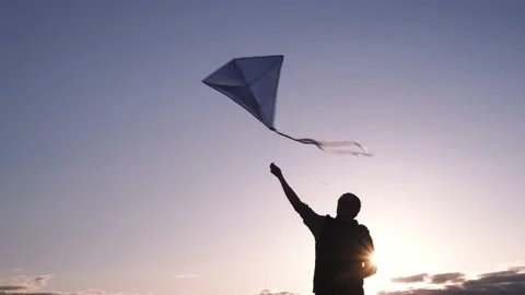 Blue kite soars in the sunset sky. Stock Footage 153415535