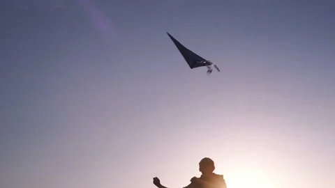 Blue kite soars in the sunset sky. Stock Footage 153415556