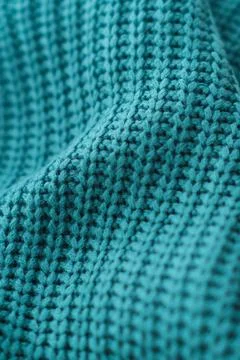 A blue knit sweater with a pattern of black and white Stock Photos