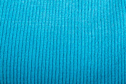 Blue knitted fabric as background Stock Photos