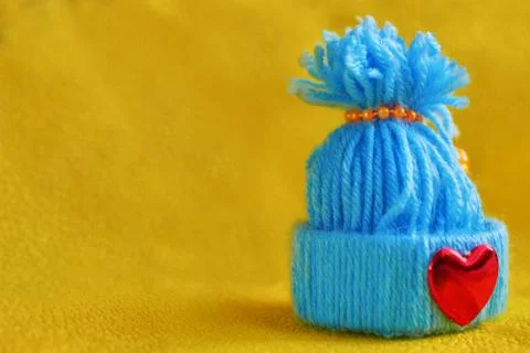 Blue knitted hat with a heart Stock Photos